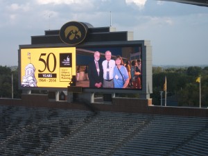 The SURP 50th anniversary dinner took place after the conference at the Kinnick Stadium Press Box. The photographer posted photos from a reception on Friday night at the downtown hotelVetro on the stadium's Jumbotron. It was not my first appearance on a Jumbotron--that was in Fenway Park in April 2011--but that is another story for another time. With m in this image are Professor John Fuller and my wife, Jean.