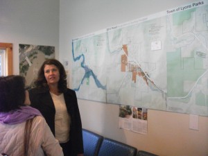 Victoria Simonsen explains the flood maps at the visitor center in downtown Lyons.