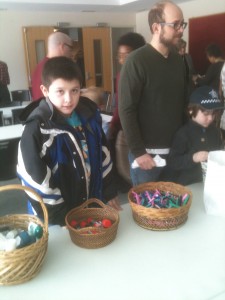 Our grandson, Angel, helps fill zip-lock bags with toiletries for The Night Ministry at Augustana Lutheran Church. 